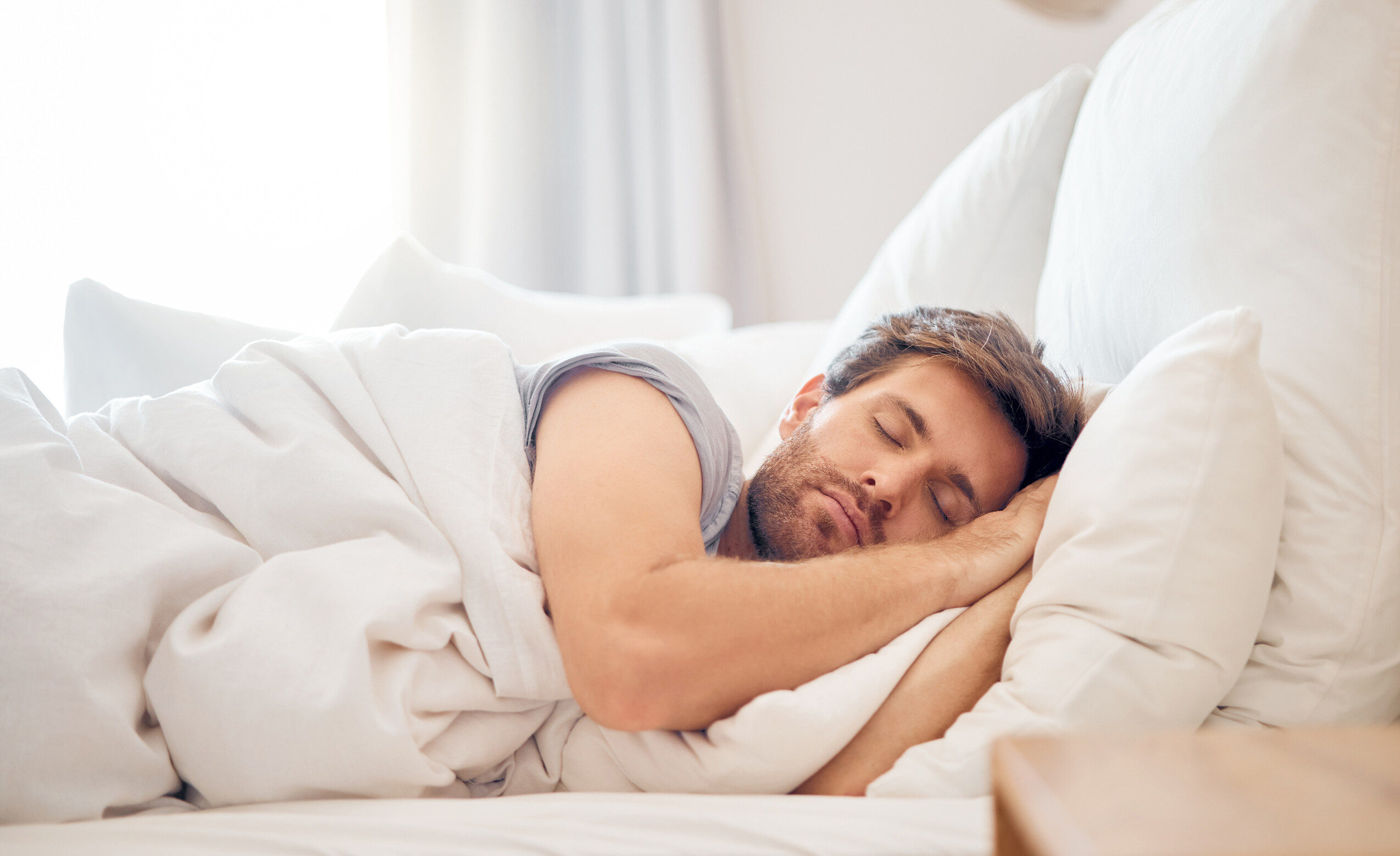 Home bedroom sleeping man morning lying his head pillow apartment space tired fatigue relax male taking time off weekend bed airbnb hotel accommodation